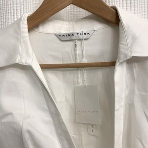 Trina Turk white cotton peplum style blouse.